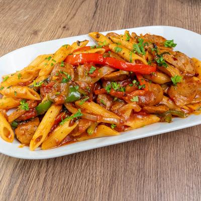 Greco Diablo pasta dish served on a wooden table.