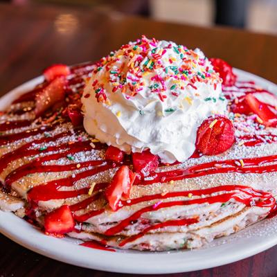 A stack of Strawberry Cheesecake Griddle Cakes.