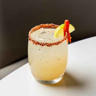 A Spicy Thai Margarita with a chili pepper and lime garnish.