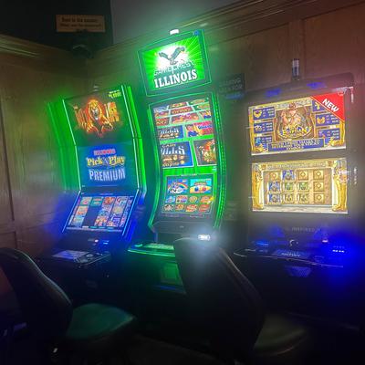 Three colorful, illuminated slot machines.