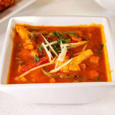 Chunks of bell pepper, onion, and tomato cooked in a tomato based sauce.