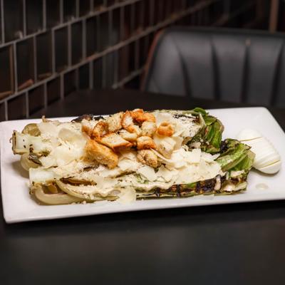 Grilled Caesar salad on a rectangular plate.