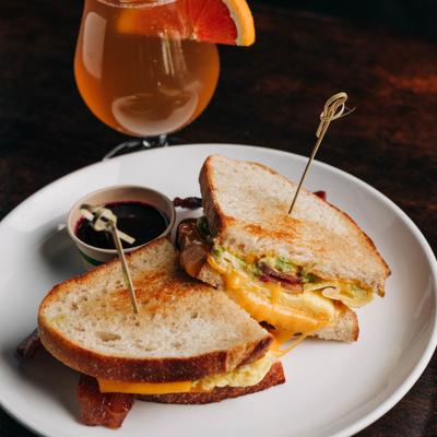 Breakfast sandwich served with dipping sauce and lavender orange kombucha.