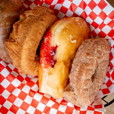 Portion of four different donuts.
