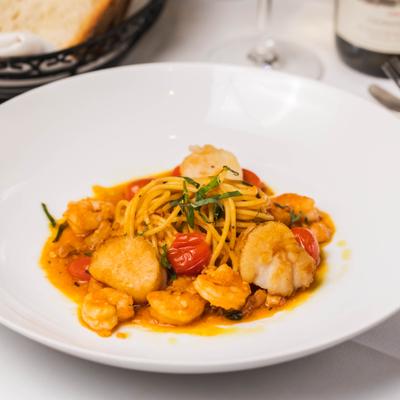 Seafood pasta with scallops, shrimp, and cherry tomatoes.