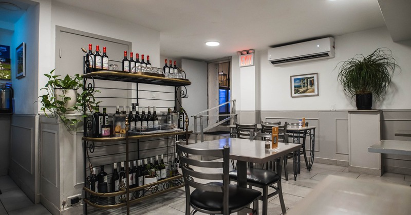 Interior, seating place with tables and chairs, decorated with pictures