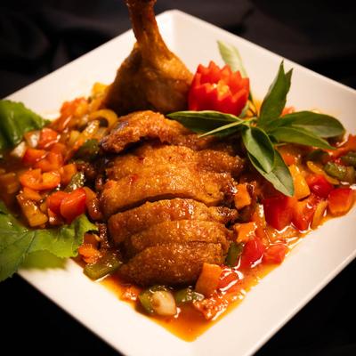 Duck meat, with bell peppers, carrots, and sweet and sour sauce.