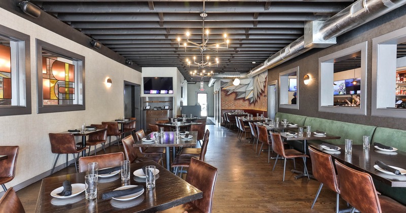 Interior, dining area, wooden top tables for four and two, leather covered chairs