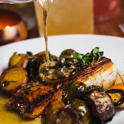 Halibut filet with cooked artichoke hearts and sauce