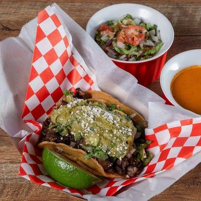 Taco with lime wedge salsa and pico.