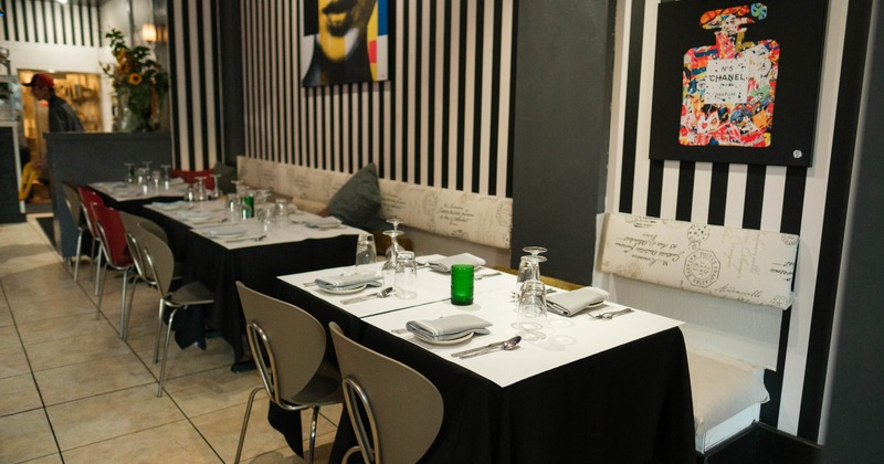 Interior, tables set for guests in dining area