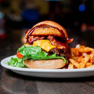 Cheeseburger with bacon, onion ring, and fries.