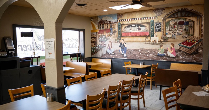 Interior, tables ready for guests, wall mural art