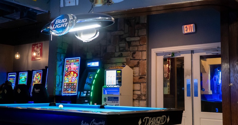 Interior, pool table and various gaming machines in the back
