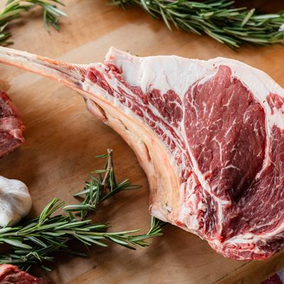 Raw Steak Chop on a Cutting Board.
