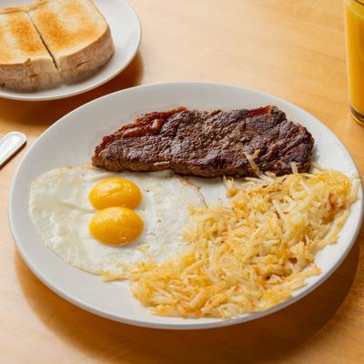Steak and eggs with a side of hash browns.
