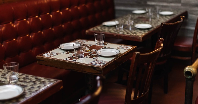 Interior, banquette seating, tables ready for guests
