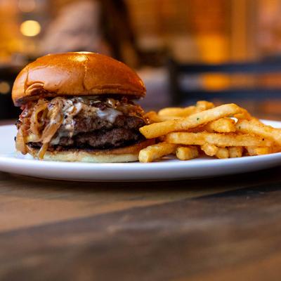 Double Smash Burger, with American cheese, caramelized onions, and fries.
