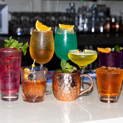 Assortment of cocktails displayed on bar counter.