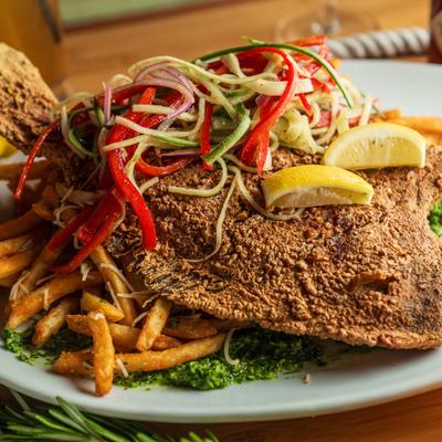 Crispy flounder fish, with vegetables and fries.