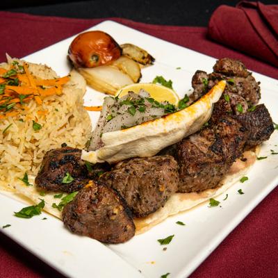 Beef kabob, with rice and grilled vegetables.