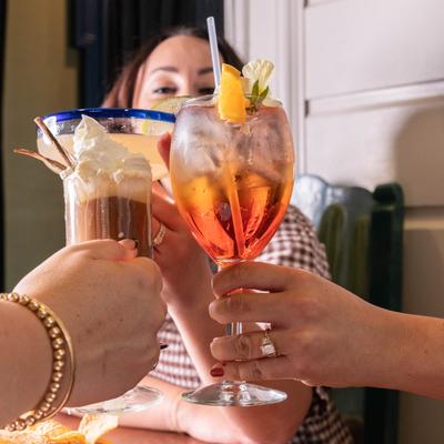 Customers toasting with cocktails.
