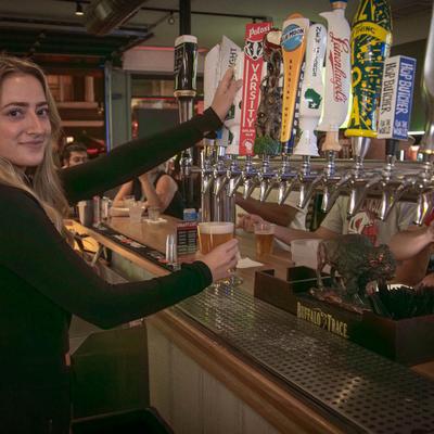 A person pouring drinks from the dispensary.