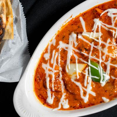 Chicken Tikka Masala and a basket of naan.