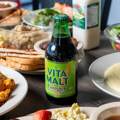 Various food and a bottle of ginger malt.