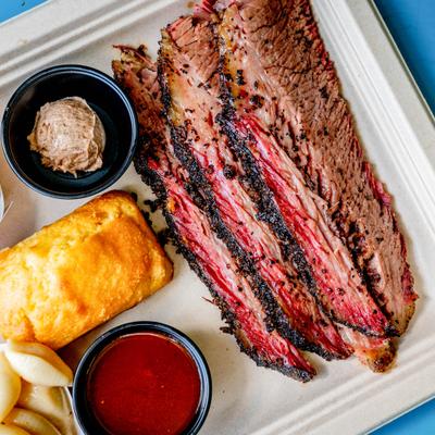 Sliced Brisket Plate featuring a variety of sides, close-up.