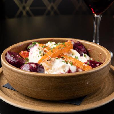 Roasted Root Vegetable served with a glass of red wine.