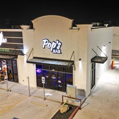 Exterior with illuminated signage at night.