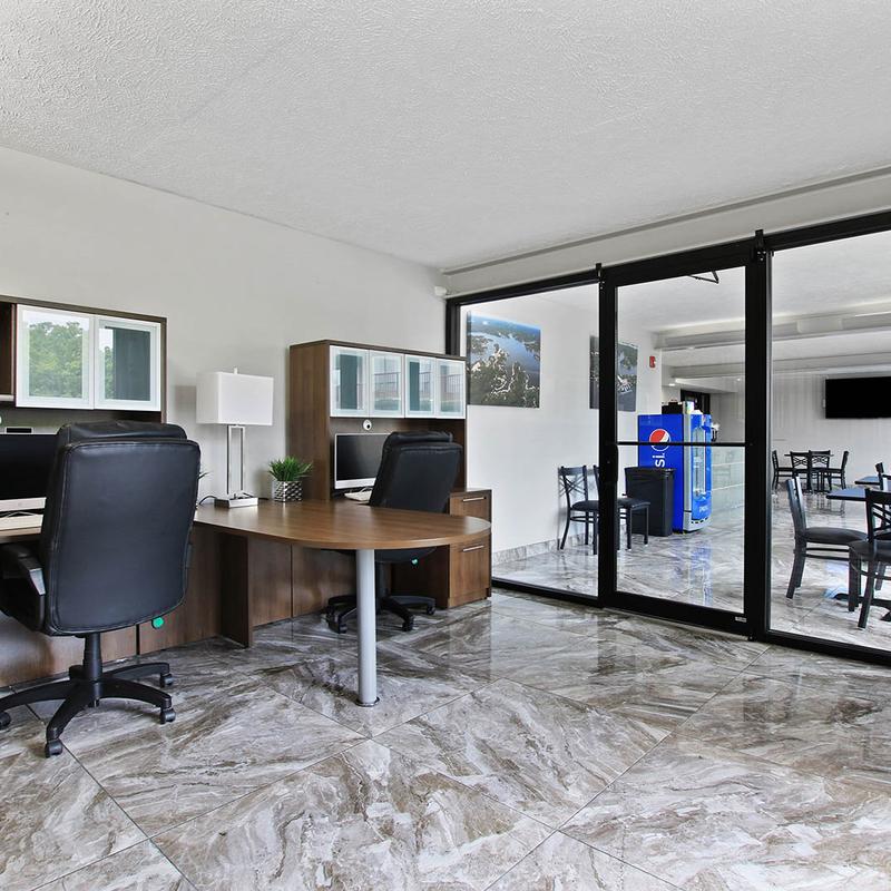 Office space and a dining area behind glass doors.