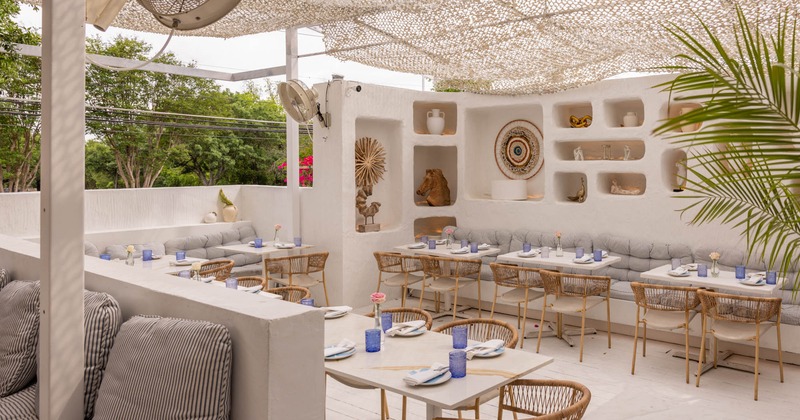 Covered exterior seating area with chairs and tables, Mediterranean ambient