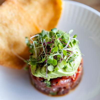 Tuna tartare with avocado, micro greens, and tortilla chips.