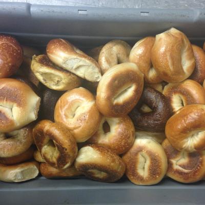 Plain bagels in a large bin.