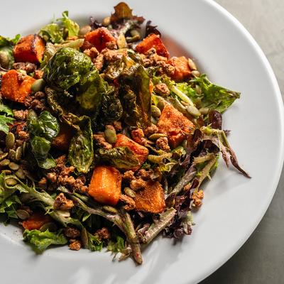 Fall salad with greens roasted vegetables and nuts.