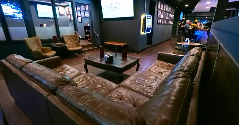 Interior, few sofas in front of a large TV