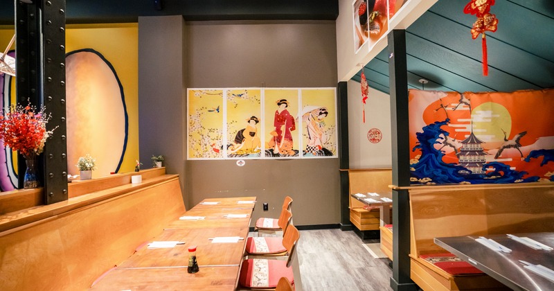 Sushi bar interior with decor on the wall and wooden benches