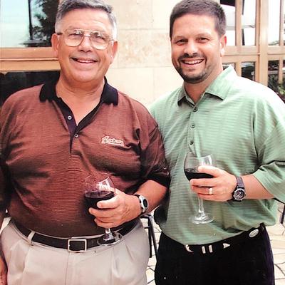 Ciro and Papa C holding a glass of wine.