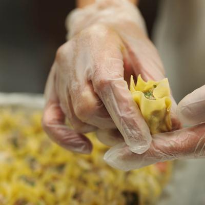 Hands preparing food.