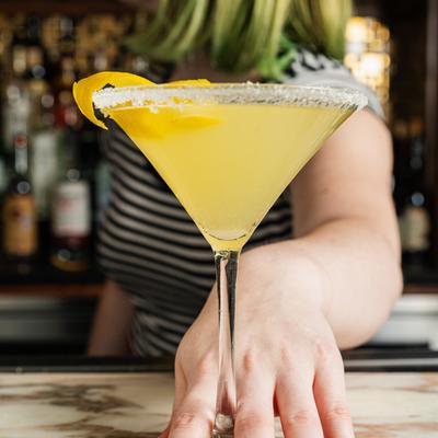 Lemon Drop Cocktail served on bar counter by a bartender