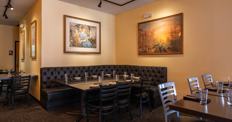 Restaurant interior, dining area, dining booth in the corner set for eight guests