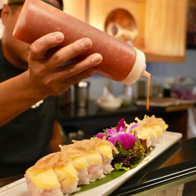 A staff member preparing a meal.