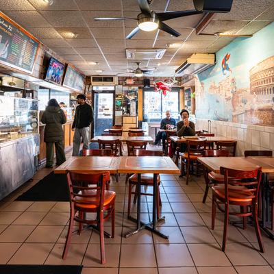 Casual restaurant interior with tables and counter.