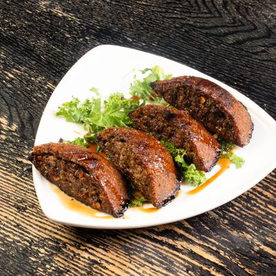 grilled beef Kibbeh topped with pomegranate molasses.