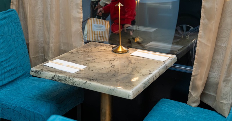 Marble table and upholstered blue chairs