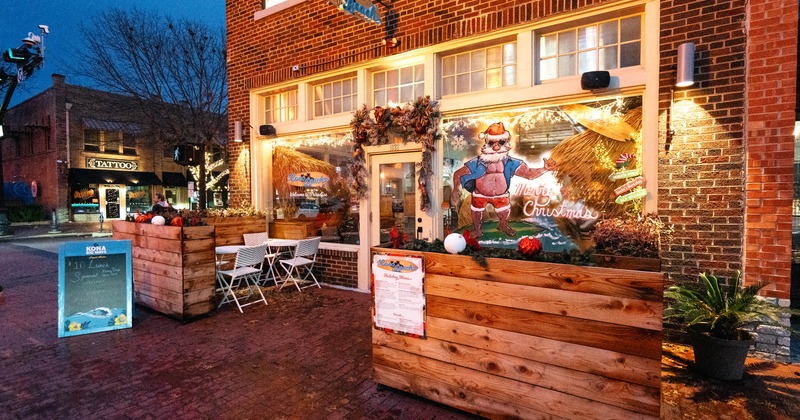 Exterior, front view, garden with tables and chairs in front the entrance