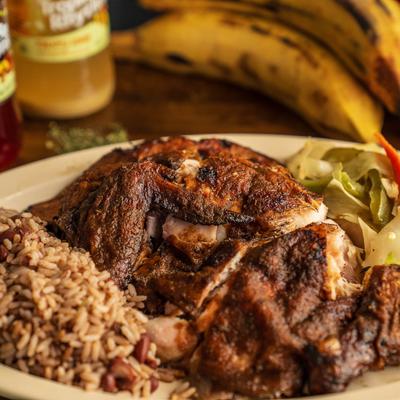 Dark jerk chicken dish plate, close up.
