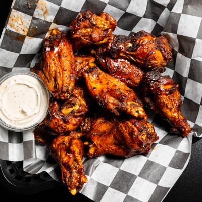 Chicken wings served a with dipping sauce.